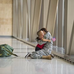 Veteran hugs child