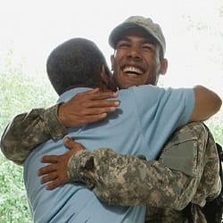 father hugs soldier son