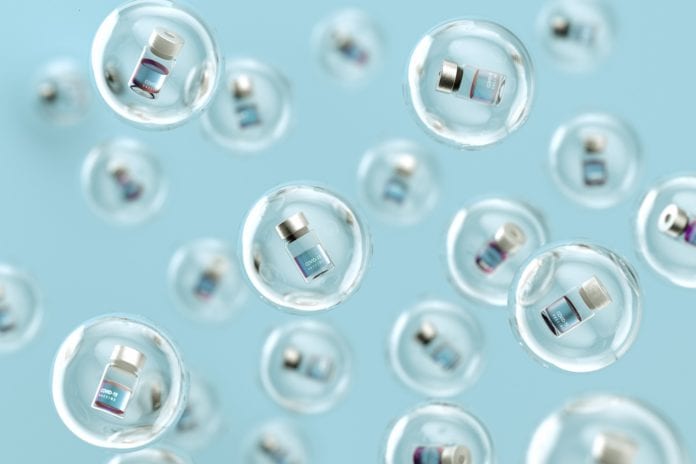 covid-19 vaccine bottles inside bubbles