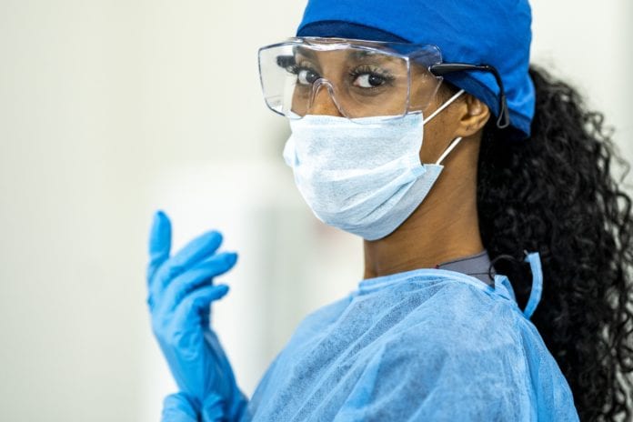 woman medical professional wearing personal protective equipment (ppe)