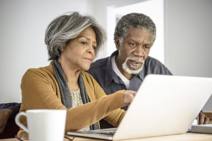 senior couple working together on laptop