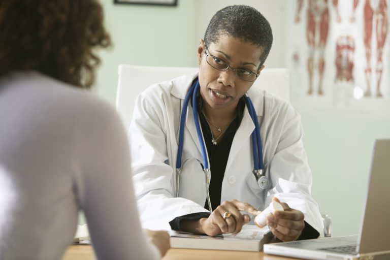 woman doctor speaking with woman patient