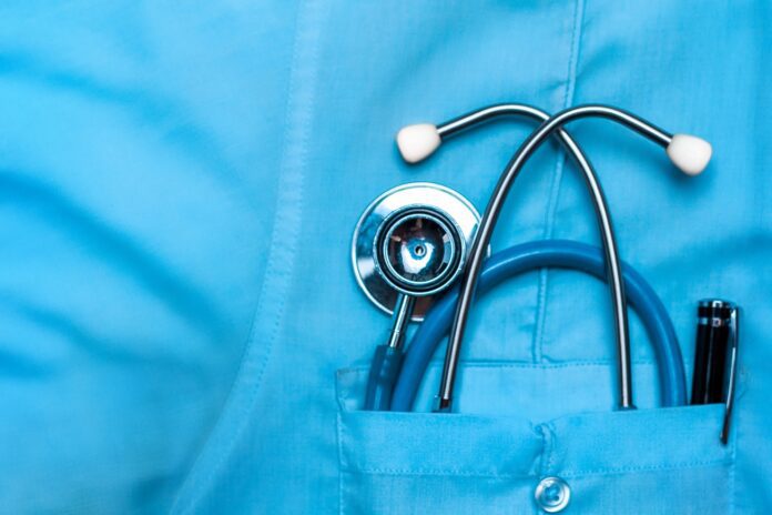 closeup of stethoscope in front pocket of health care provider