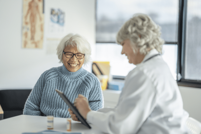 elderly patient providing personal information to physician