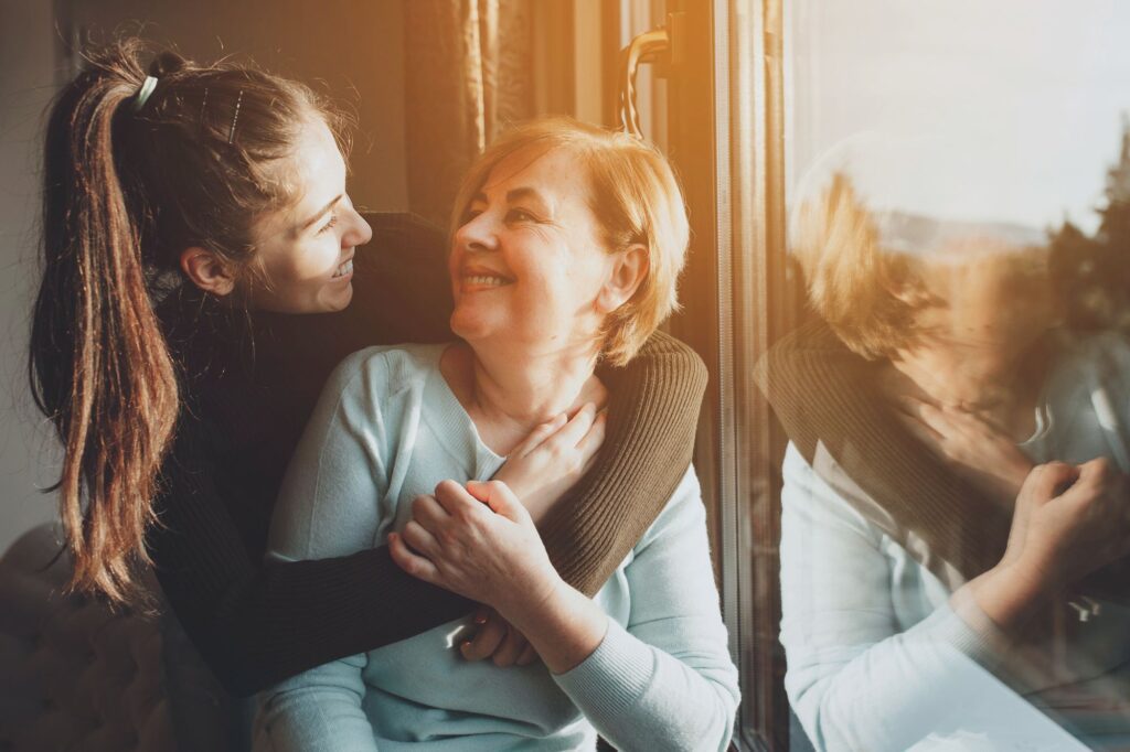 patient hugs and smiles at caregiver